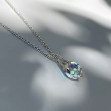 Load image into Gallery viewer, Silver necklace with multifaceted aurora borealis crystal pendant. Chain is made from polished 925 (sterling) silver, pendant made from crystal glass. The length of the chain is 50 cm, the pendant is 18mm long.